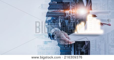 Double exposure of Building constructure and Image of engineer holding a plan and check blue print. selective focus