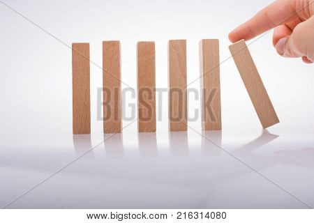 Hand Holding Wooden Domino