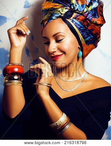 beauty bright african american woman with creative make up, shawl on head like cubian closeup