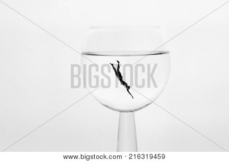 miniature diver in a glass of water