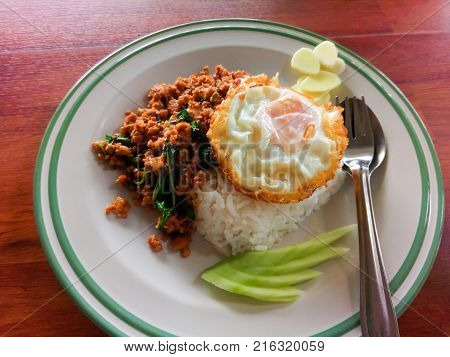 Street food in Thailand. rice with stir-fried of pork and basil leaf with fried egg hot and spicy.
