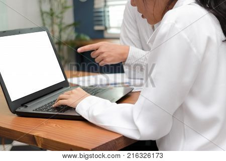 Cropped image of hardworking business people working together on a laptop computer at office. Teamwork brainstroming concept