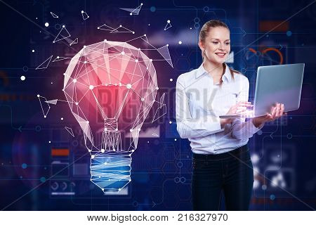 Attractive smiling european woman using laptop with abstract glowing polygonal light bulb hologram on blurry background. Innovation and idea concept. 3D Rendering