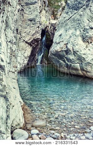 Cascade on the mountain river in the canyon in summer.