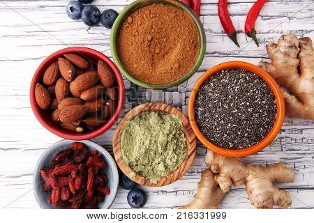superfood concept with bowls in diffrent colors of various superfoods.