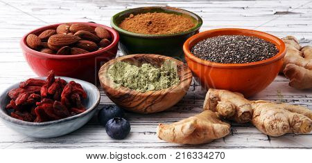 superfood concept with bowls in diffrent colors of various superfoods.