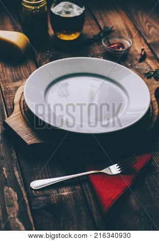 Empty plate on the home wooden rustic table