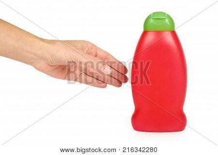 Red plastic bottle for shampoo in hand isolated on white background. Hydiene and cleaning idea.
