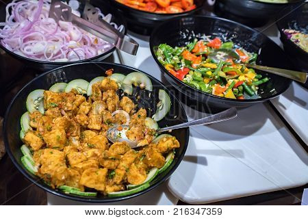 Close up metal containers with prepared dishes for buffet breakfast in hotel