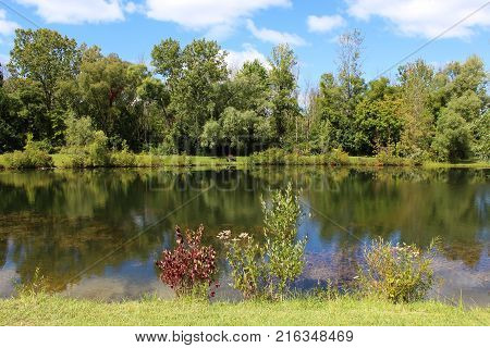Autumn colors and blue skies reflecting in the water