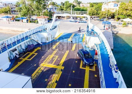 Pefki Island Evia Greece - 11 July 2017: Anchored large ferryboat has opened his front entrance for boarding passengers at the local port.