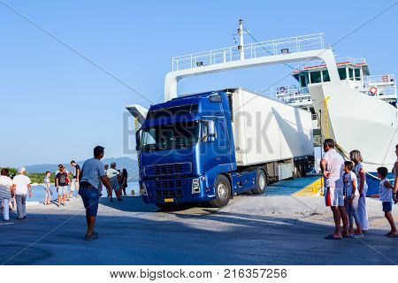 Pefki Island Evia Greece - 11 July 2017: Anchored large ferryboat has opened his front entrance for unloading vehicles at the local harbor