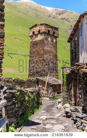 View of the Ushguli village at the foot of Mt. Shkhara. Picturesque and gorgeous scene. Rock tower in Ushguli - the highest inhabited village in Europe