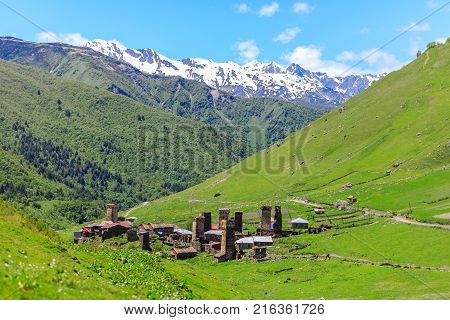 View of the Ushguli village at the foot of Mt. Shkhara. Picturesque and gorgeous scene. Rock tower in Ushguli - the highest inhabited village in Europe