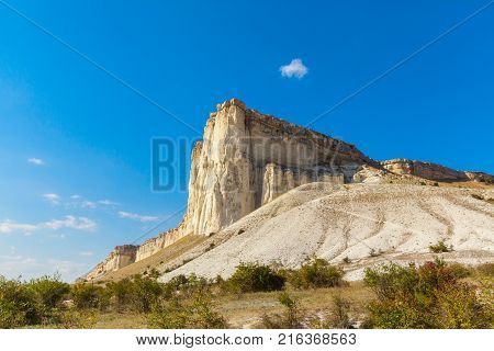 View of White rock or Aq Qaya on a Sunny summer day. Crimea. White limestone with a vertical cliff