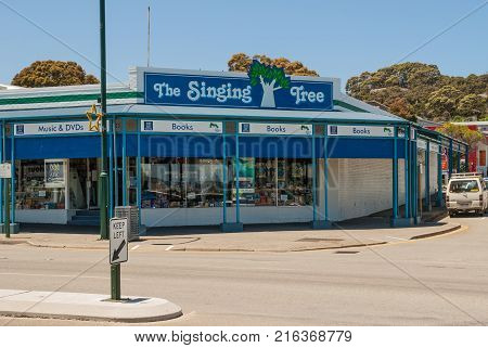 Albany WA Australia - November 23 2009: Music and book store on corner of York Street main shoppng drag under blue sky. Street scene with car. Window displays.