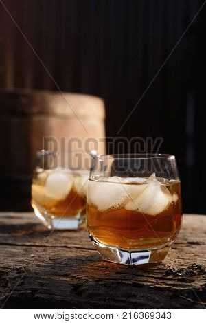 Glass Of Whiskey On Wooden Background Close Up