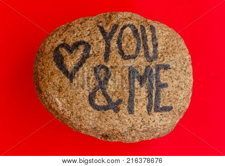 the writing you & me with a heart drawn on a stone /the writing you & me with a heart drawn on a stoneindicates the love promise of two lovers