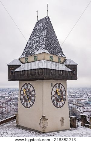 Landmark Uhrturm on hill Schlossberg in Graz on a snowy winterday