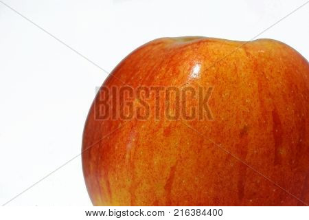 Apple red-yellow on a white background. Apple is mature shiny light reflects from it.