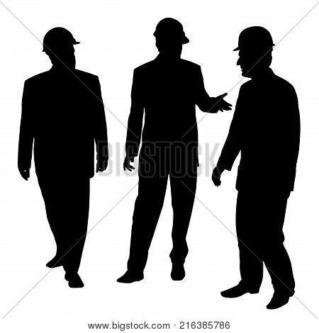 Three businessmen architects engineers or workers with a protective helmet walking and talking about new project.