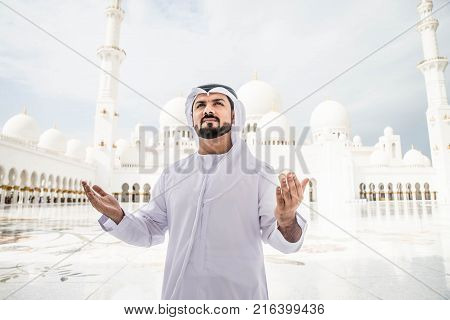 Arabian man at Sheikh Zayed Grand Mosque in Abu Dhabi United Arab Emirates.