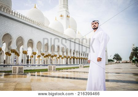 Arabian man at Sheikh Zayed Grand Mosque in Abu Dhabi United Arab Emirates.