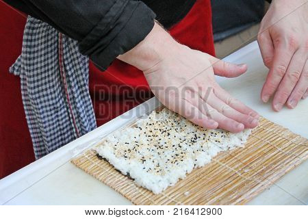 Preparation sushi roll on restaurant. Master class.