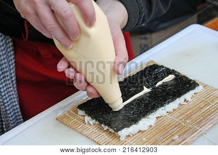 Preparation sushi roll on restaurant. Master class.