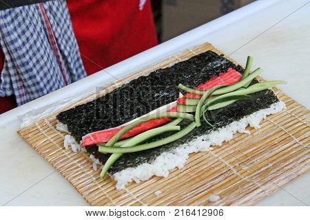 Preparation sushi roll on restaurant. Master class.