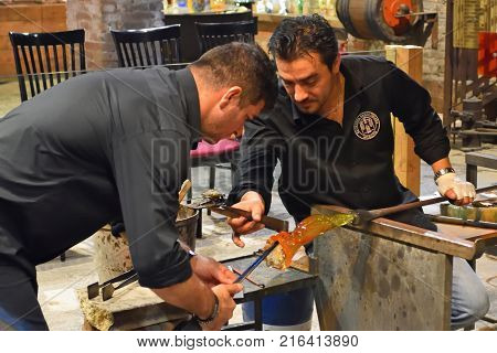 MURANO, VENICE, ITALY - SEPTEMBER 23, 2017: Murano glass workers making Vase