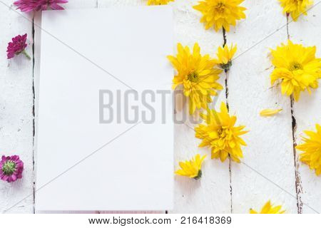 Multicolored flowers on a white wooden mocap background