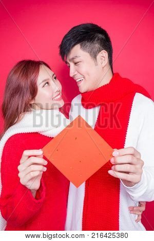 couple show couplets with chinese new year on red background