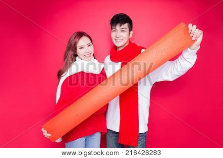 couple show couplets with chinese new year on red background
