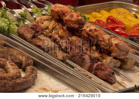 Marinated shashlik preparing on a barbecue grill over charcoal
