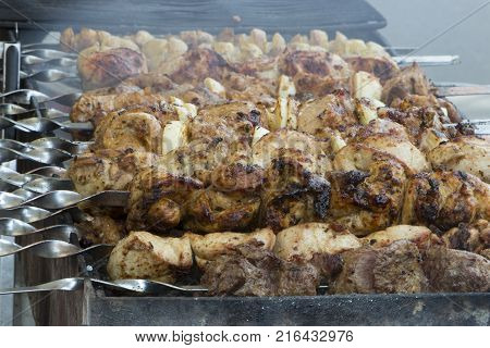 Marinated shashlik preparing on a barbecue grill over charcoal