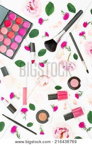 Stylish desk with woman cosmetics, accessories and pink roses on white background. Flat lay, top view. Beauty background