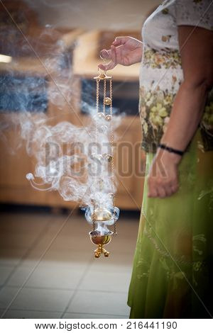 The woman holding the incense in the Orthodox Christian Church