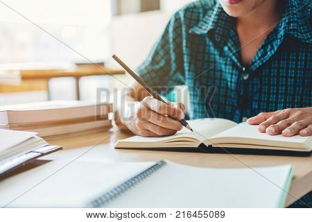 High school or college student studying and reading together in library