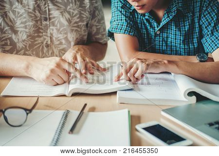 High School Or College Students Studying And Reading Together In Library