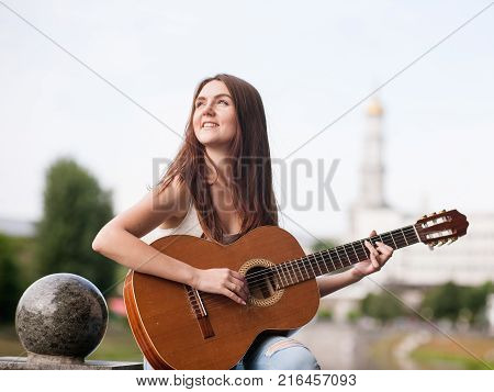 Guitar romantic city musician concept. woman playing stringed instrument. Lifestyle of talented people.
