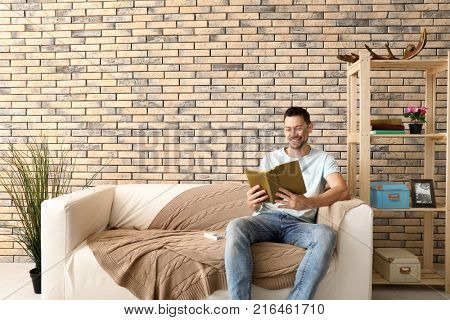 Handsome man resting in room with switch on air conditioner