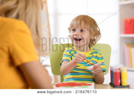 Portrait of kid little boy drawing something for art class