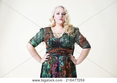 Plus size fashion model fat woman on beige studio background overweight female body