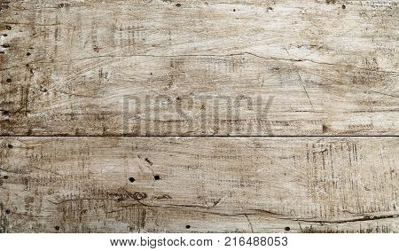 Grunge background texture of white painted wood with dark brown and black dirty stains, scratches and cracks