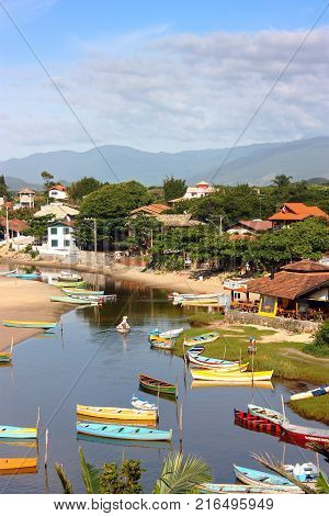 GUARDA DO EMBAU, SANTA CATARINA, BRAZIL - MARCH 20, 2009: Panoramic view of village next to the river. Many colorful boats are on the river near the mouth to the ocean.