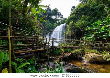 beautiful waterfall in northern Thailand name Pha dok siew waterfall in Doi intanon national park with bamboo bridge.