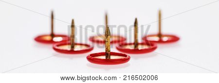 Small collection of thumbtacks on white background