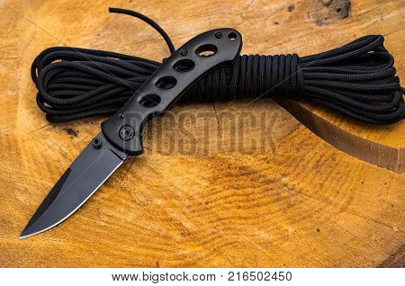 Knife for tourism and travel. The tourist cord is black. Top view.