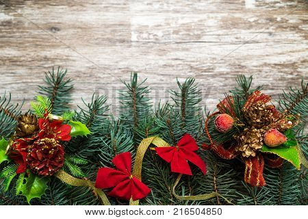 Christmas holiday background. Christmas lights lie on dark, old boards. New Year background. Christmas decorations. Xmax background. Christmas tree.